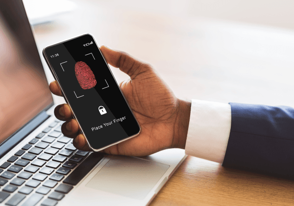 image depicting a businessman holding a phone with fingerprint scanning