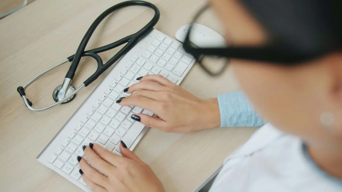 A health-care professional reviewing an email inbox